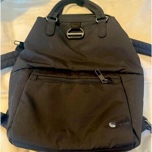 Pacsafe  - black, anti theft backpack. Made from recycled plastic materials.